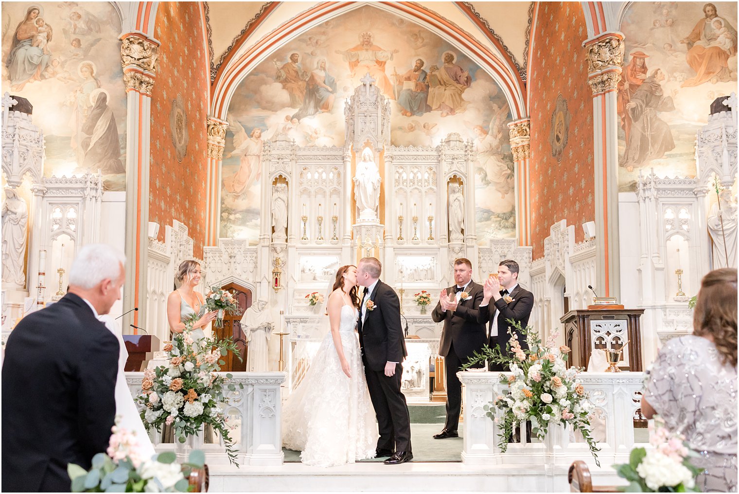 bride and groom kiss after traditional ceremony at St. Peter's Church in Point Pleasant