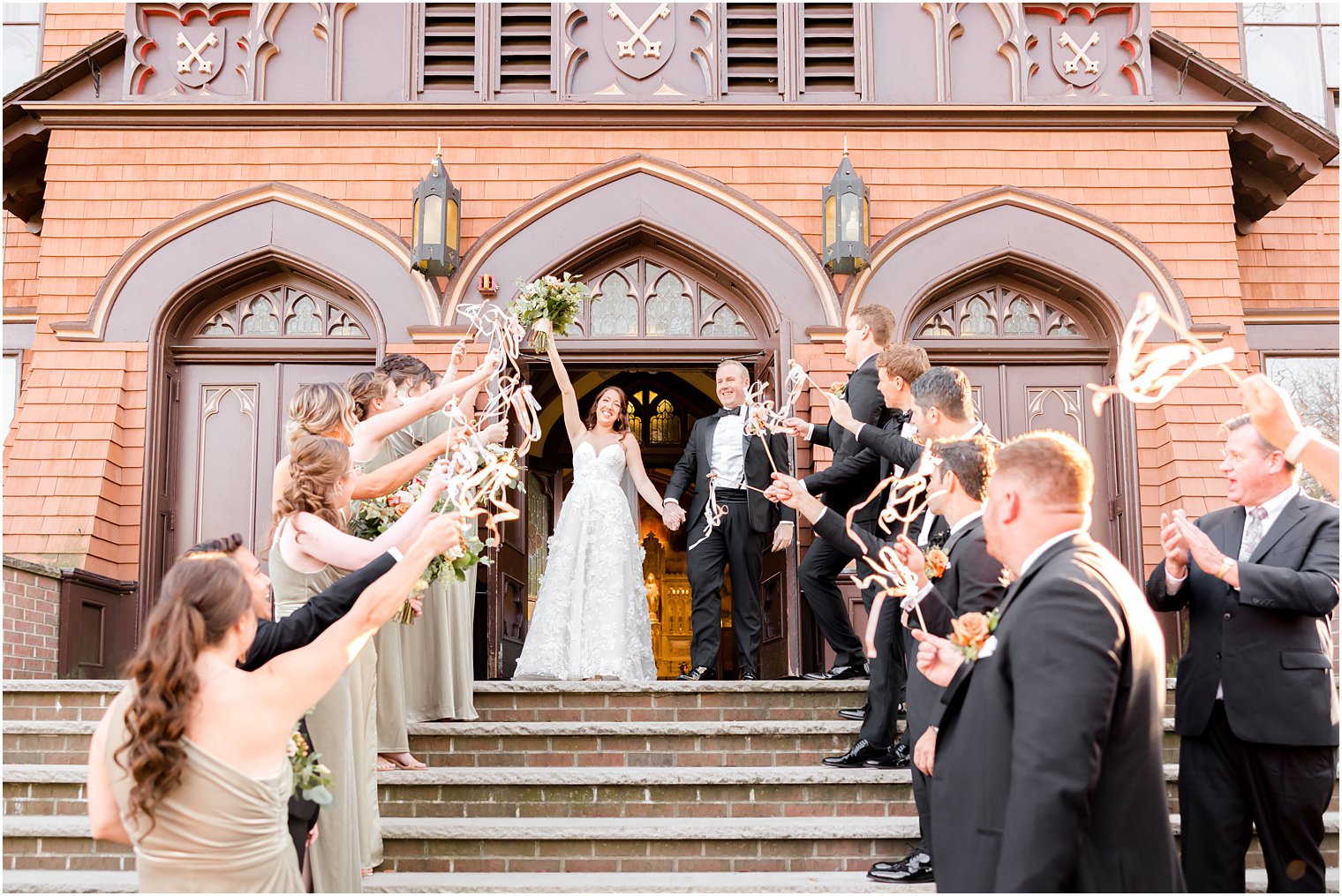 newlyweds cheer leaving traditional ceremony at St. Peter's Church in Point Pleasant