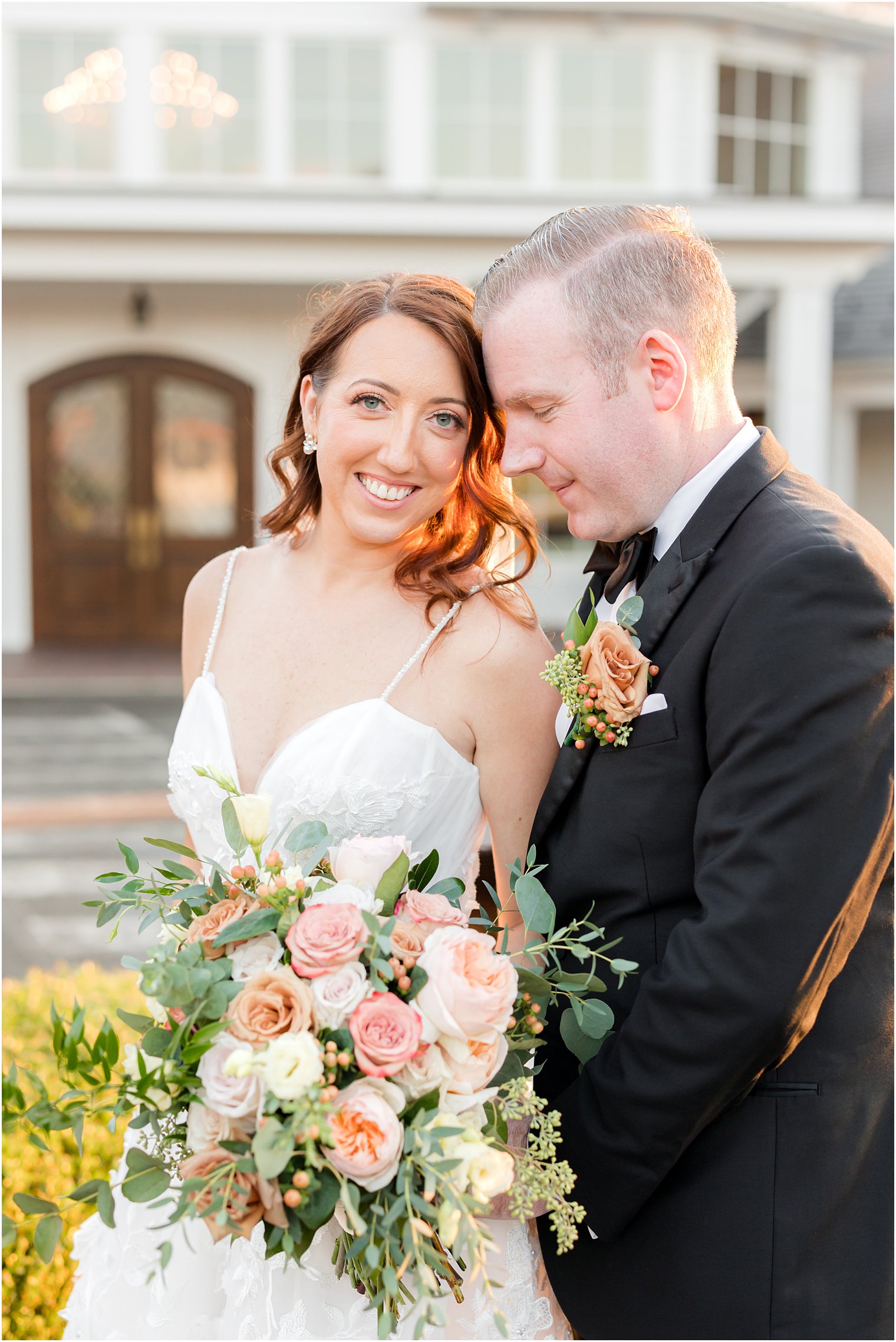 groom leads head into bride's forehead in New Jersey portraits 