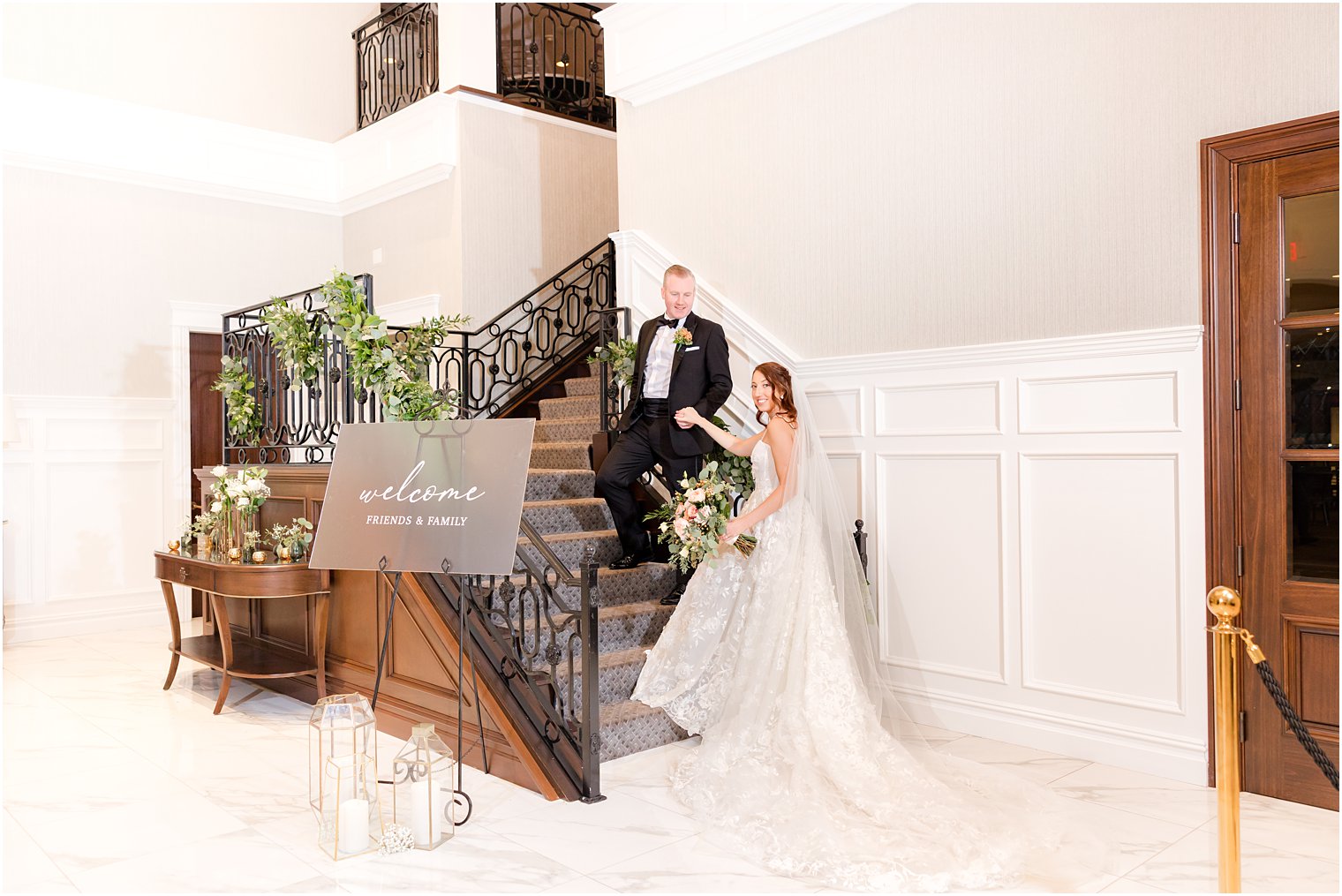 groom leads bride up steps inside The Mill Lakeside Manor