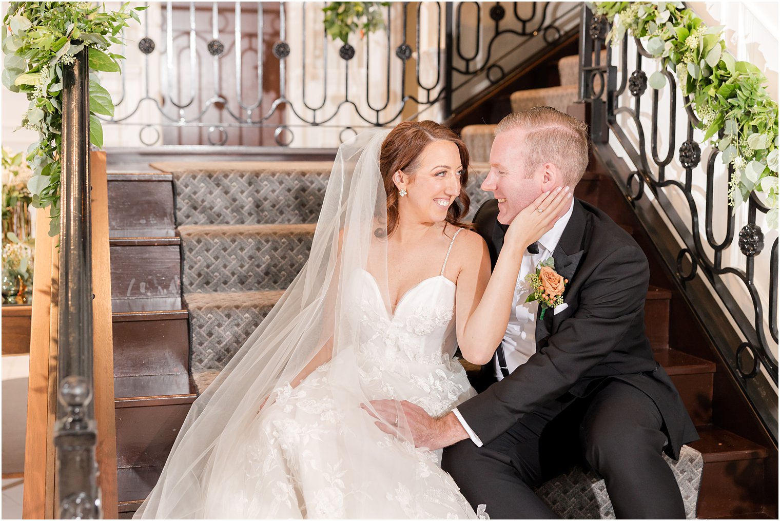 bride and groom sit on steps inside The Mill Lakeside Manor