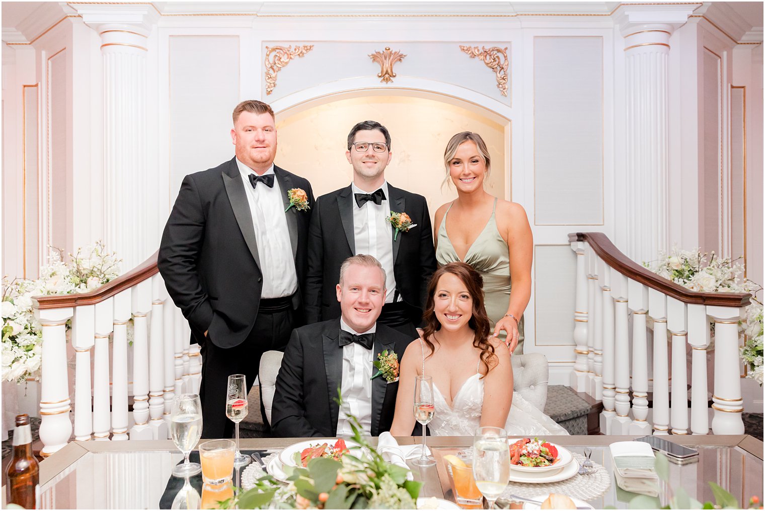 bride and groom pose with maid of honor and best men 