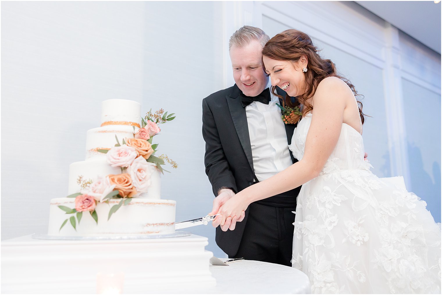 newlyweds cut wedding cake during NJ wedding reception 