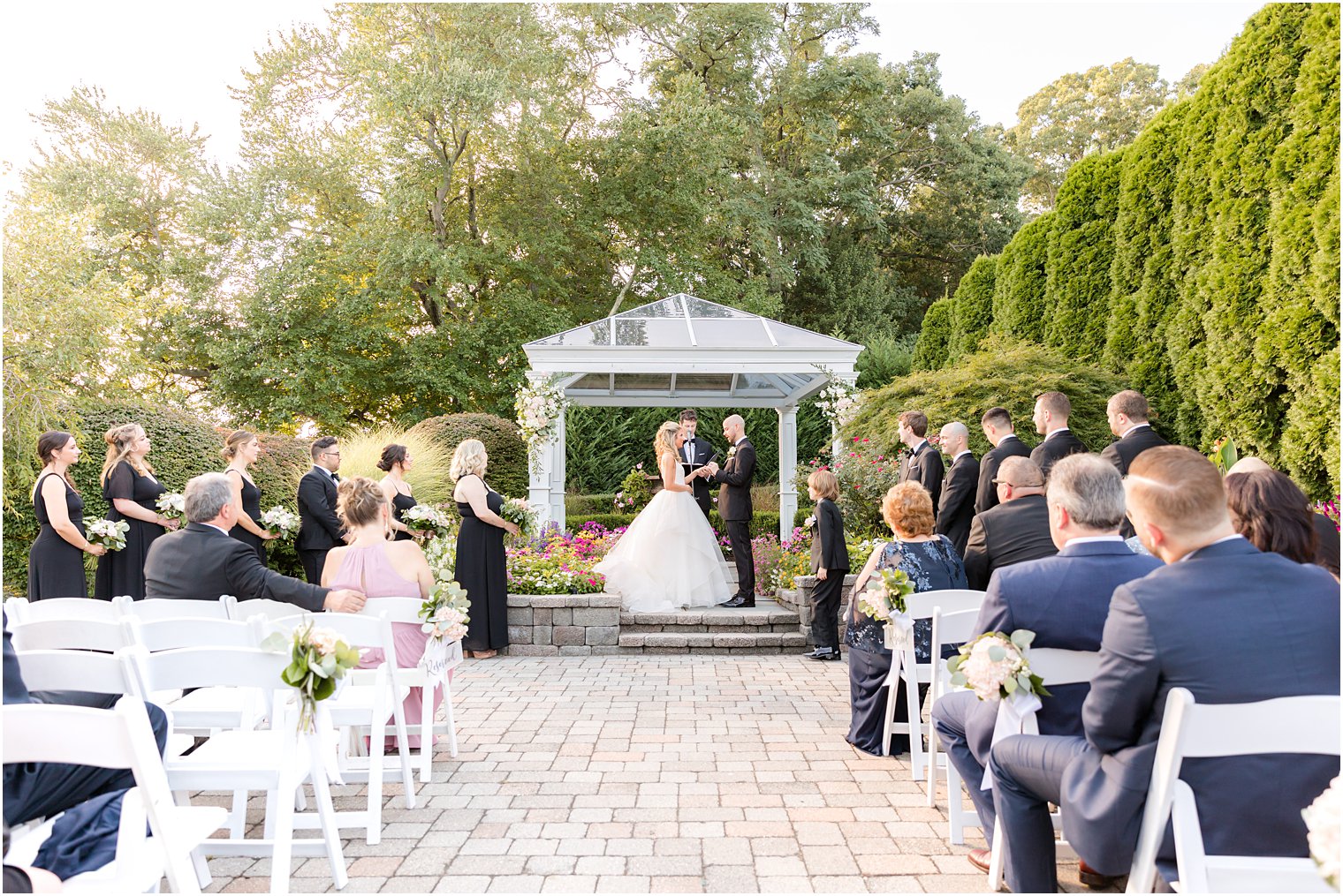 bride and groom exchange vows during fall wedding ceremony at The Mill Lakeside Manor