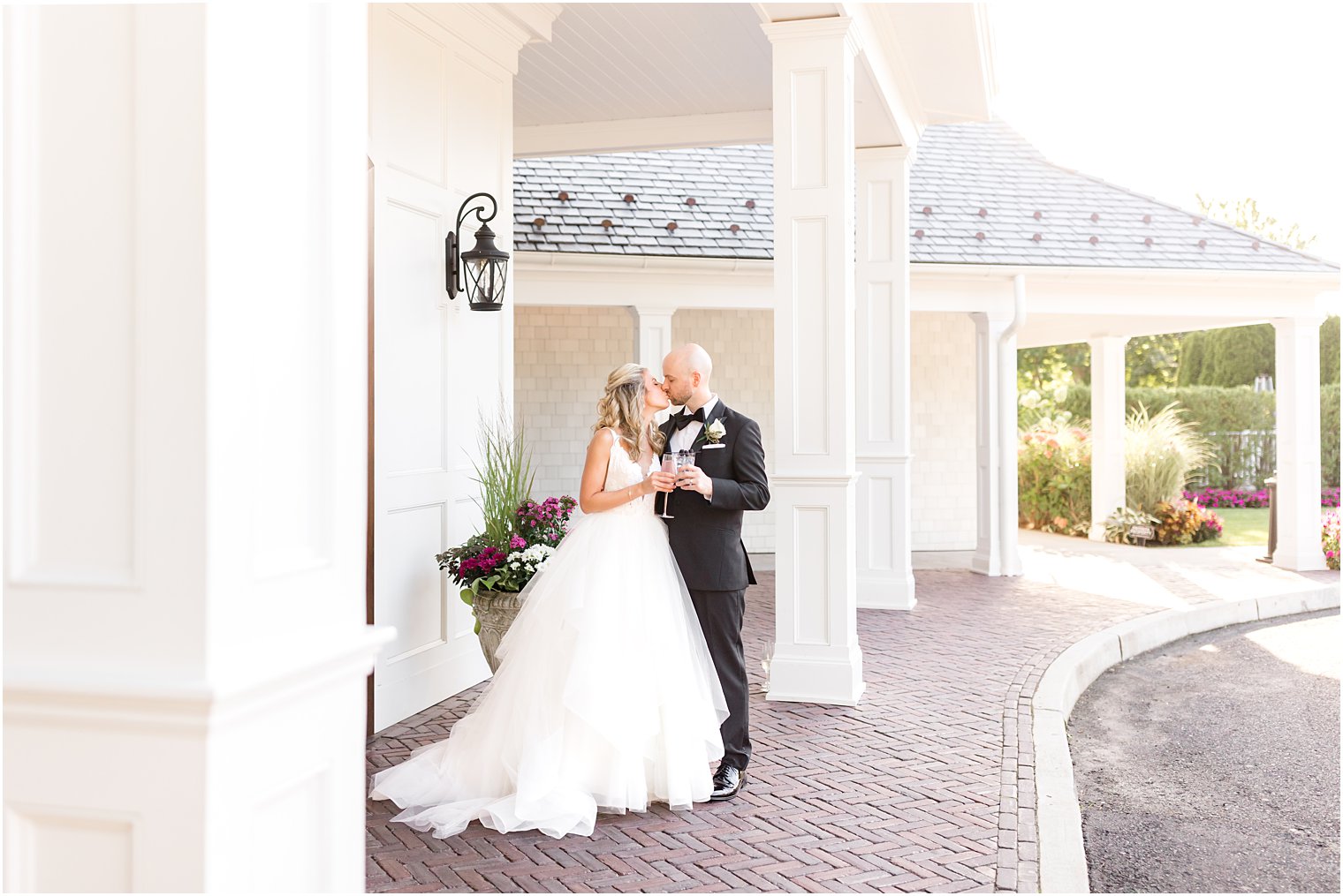 bride and groom toast champagne outside The Mill Lakeside Manor