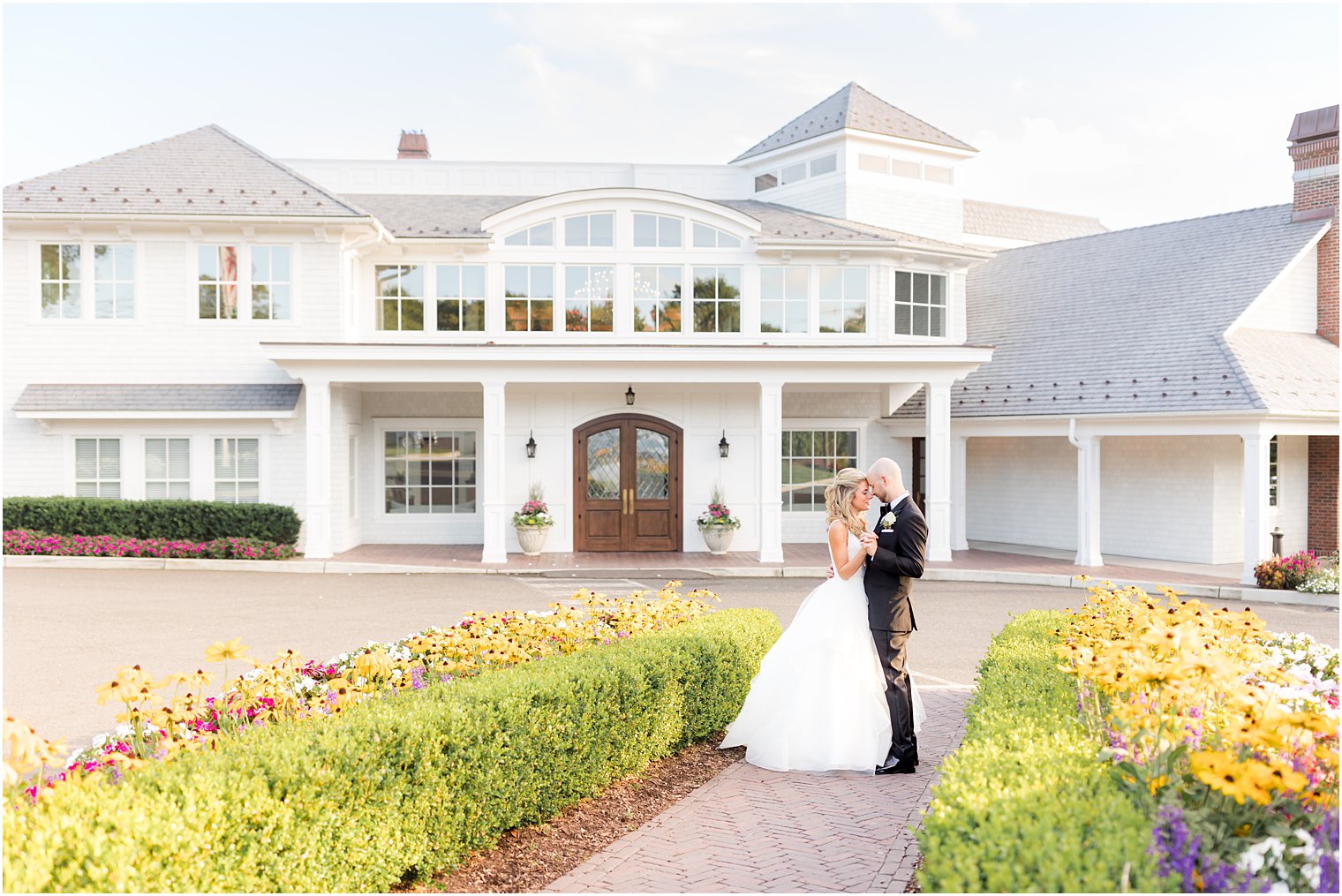 bride and groom hug outside The Mill Lakeside Manor