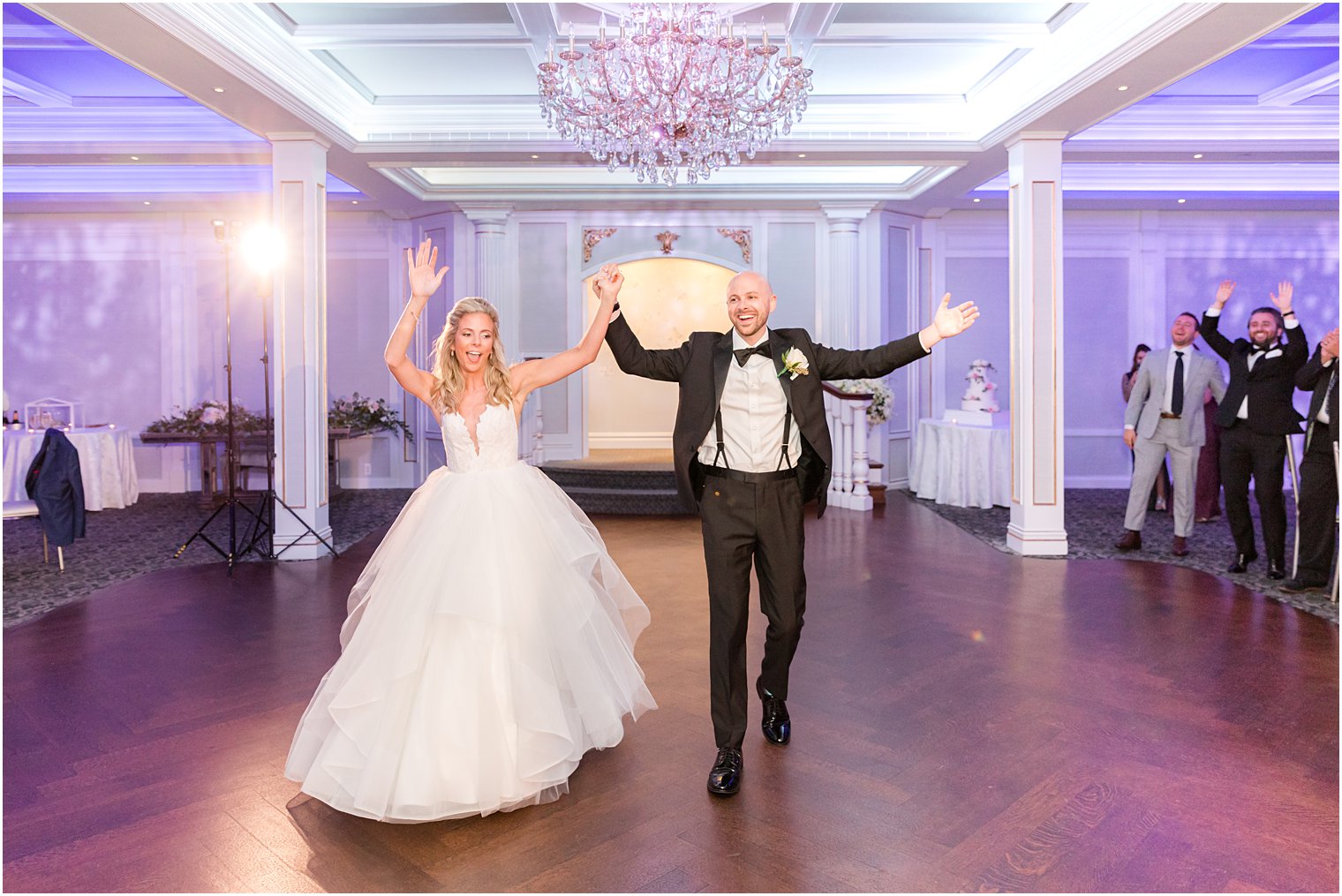 bride and groom cheer entering wedding reception at The Mill Lakeside Manor