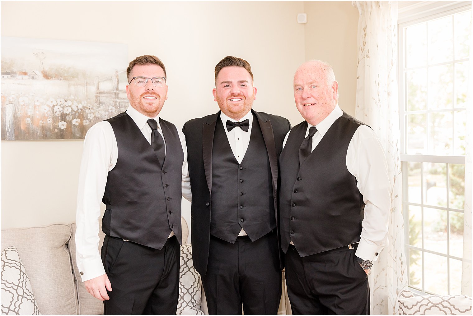 groom poses with brother and dad before Philly wedding