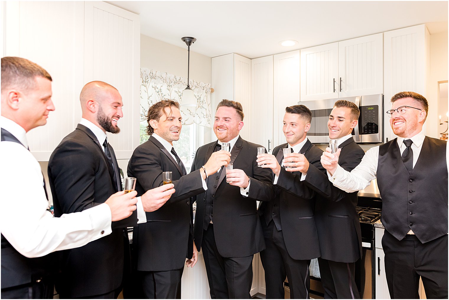 groomsmen toast in groom's home before wedding morning 