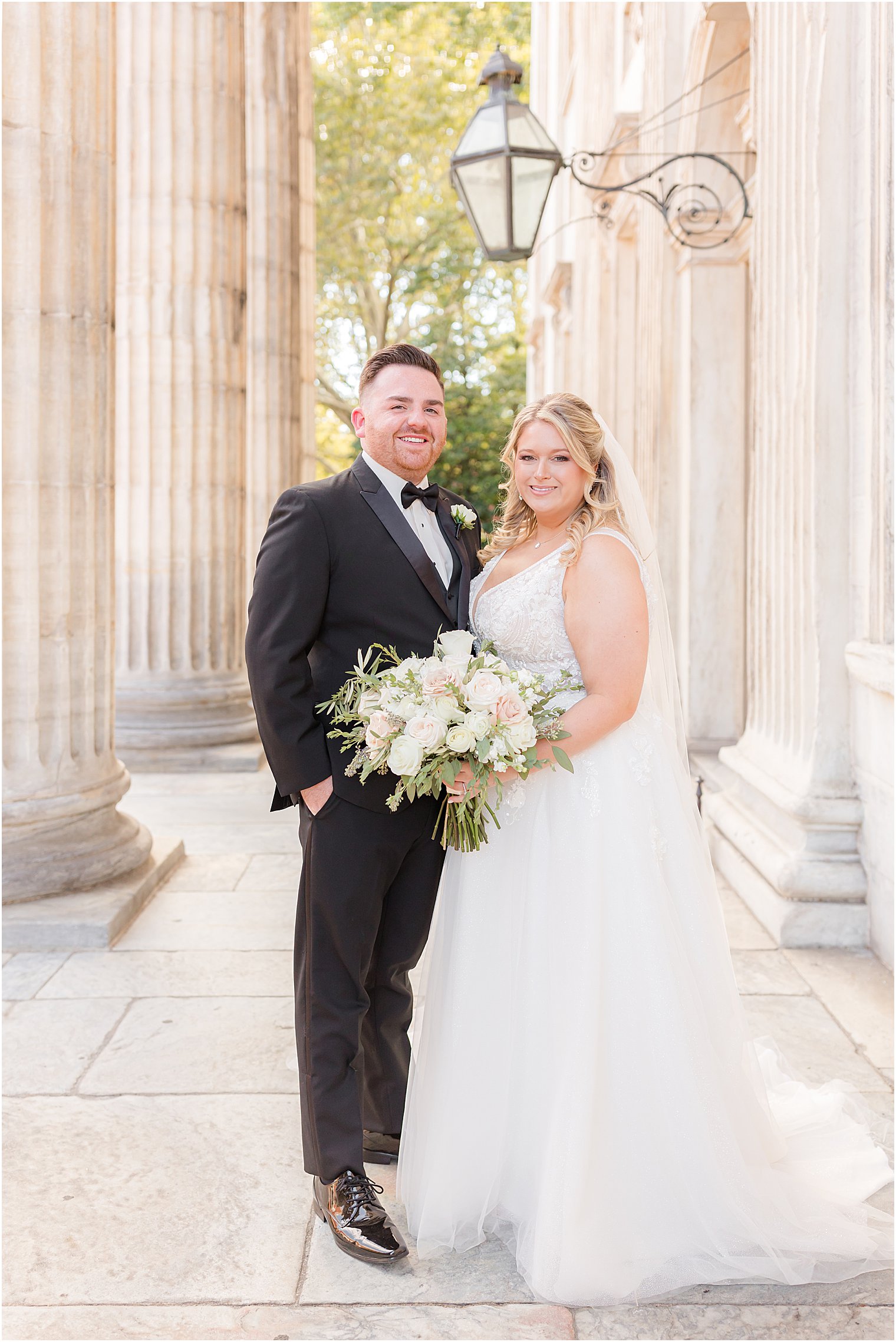newlyweds pose by entrance of First National Bank in Philly, PA