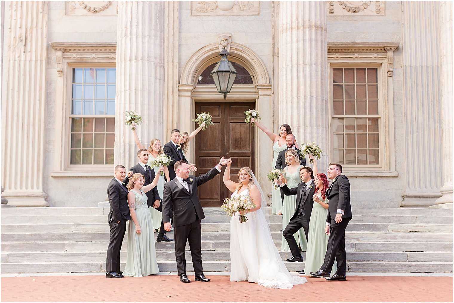 wedding party cheers for bride and groom at the First National Bank in Philly, PA