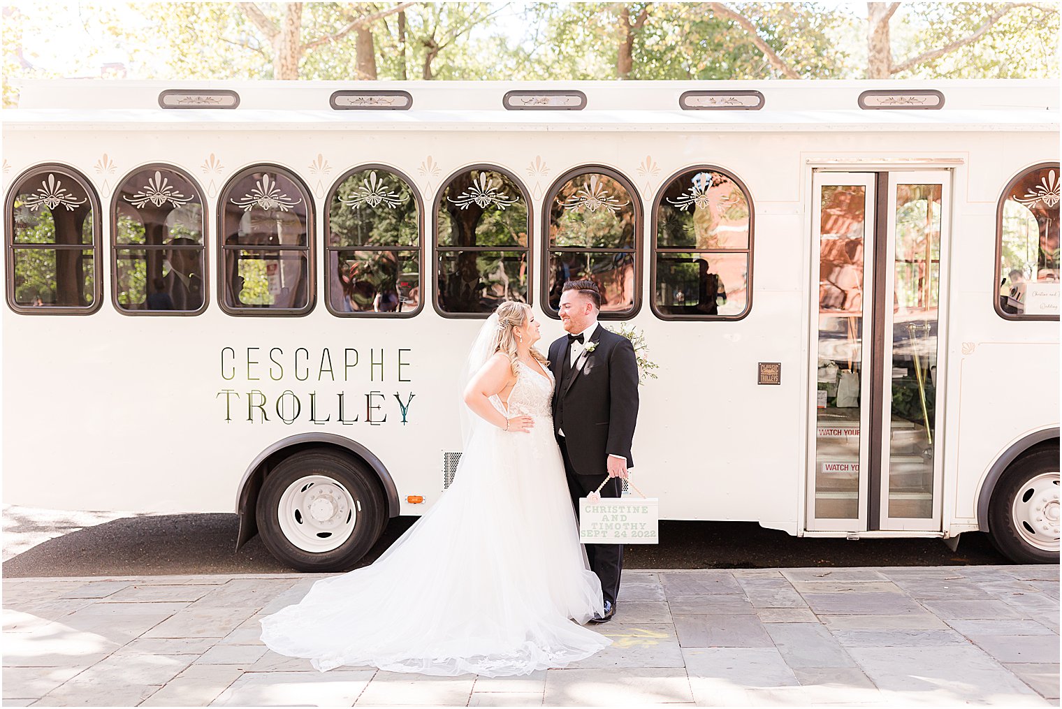 bride and groom smile together standing by Cescaphe trolley 