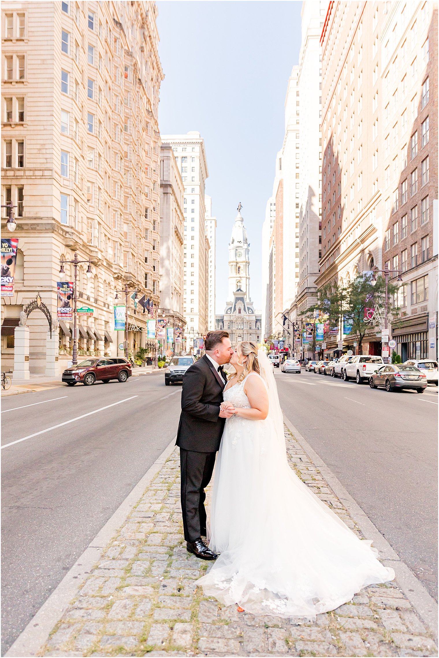 bride and groom kiss on street in Philadelphia PA