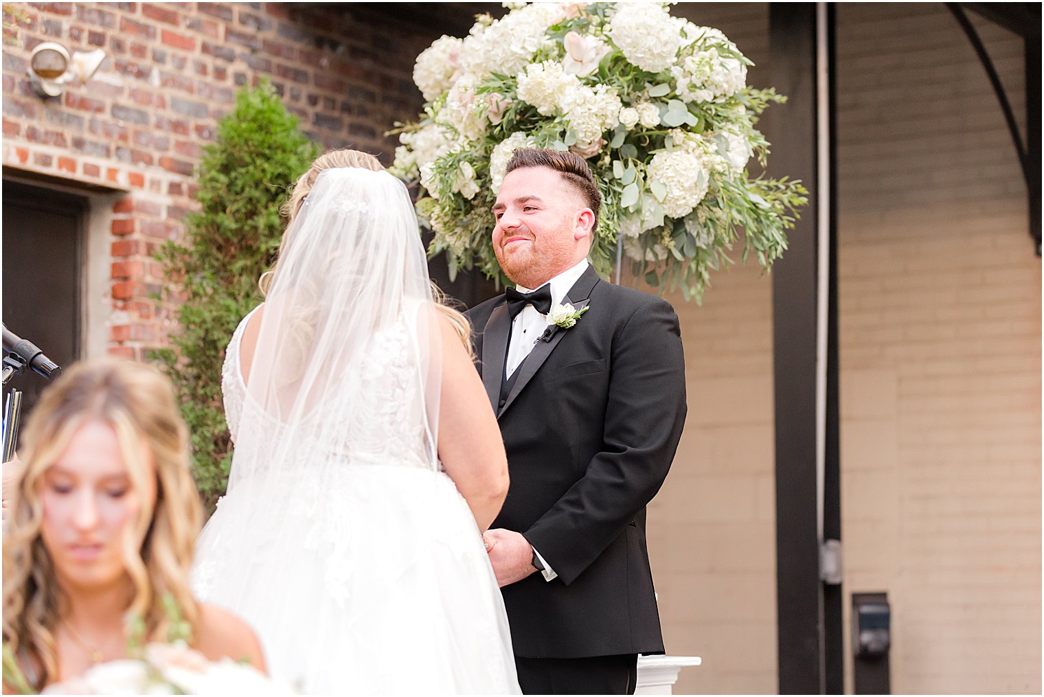 groom smiles at bride during Philly wedding ceremony 