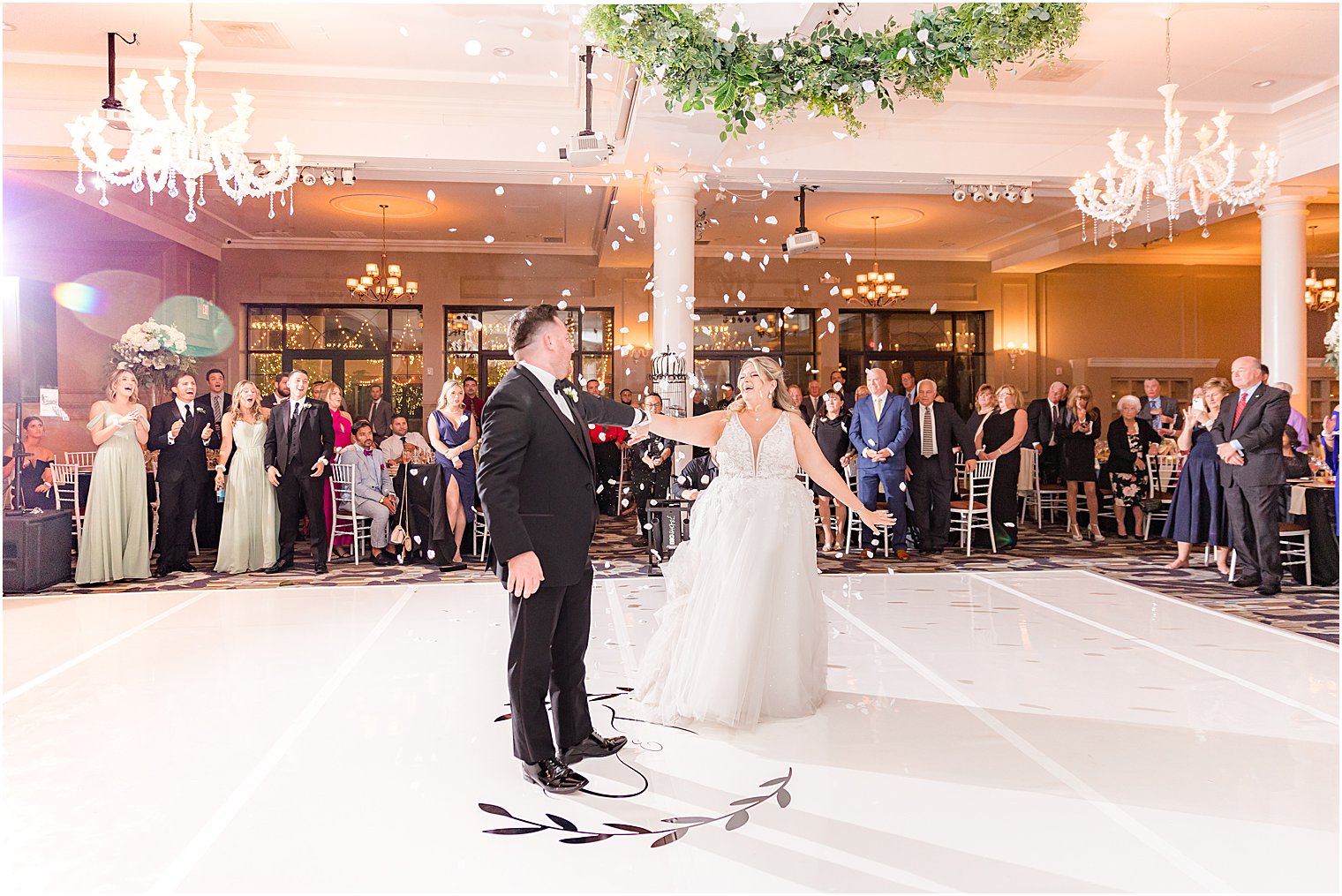 bride and groom dance during wedding reception at Vie by Cescaphe with flower petal toss