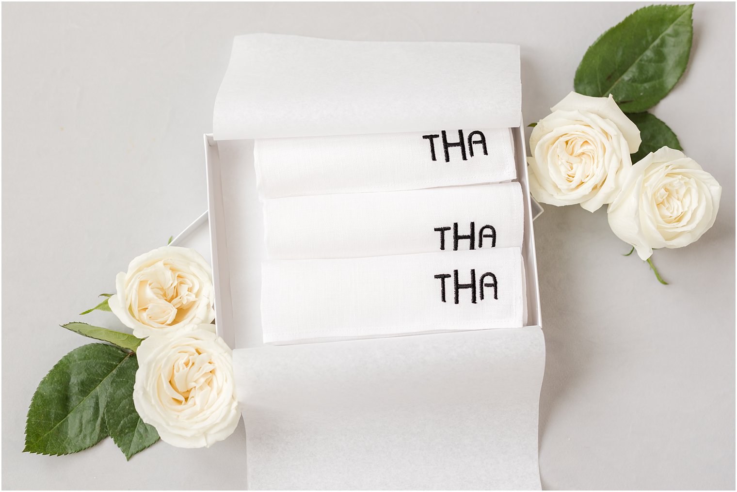 custom towels in box with white roses 