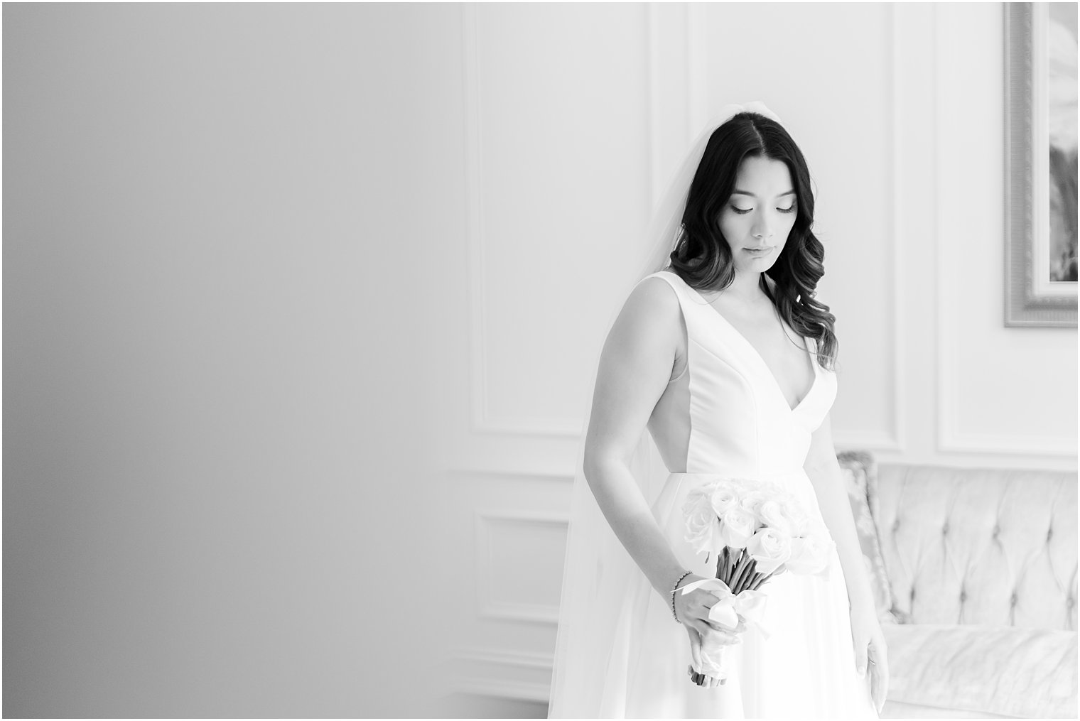 black and white portrait of bride holding bouquet of roses 