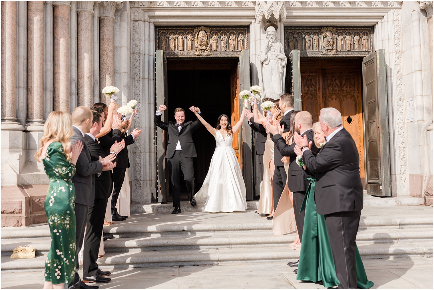 newlyweds cheer leaving The Cathedral Basilica of the Sacred Heart