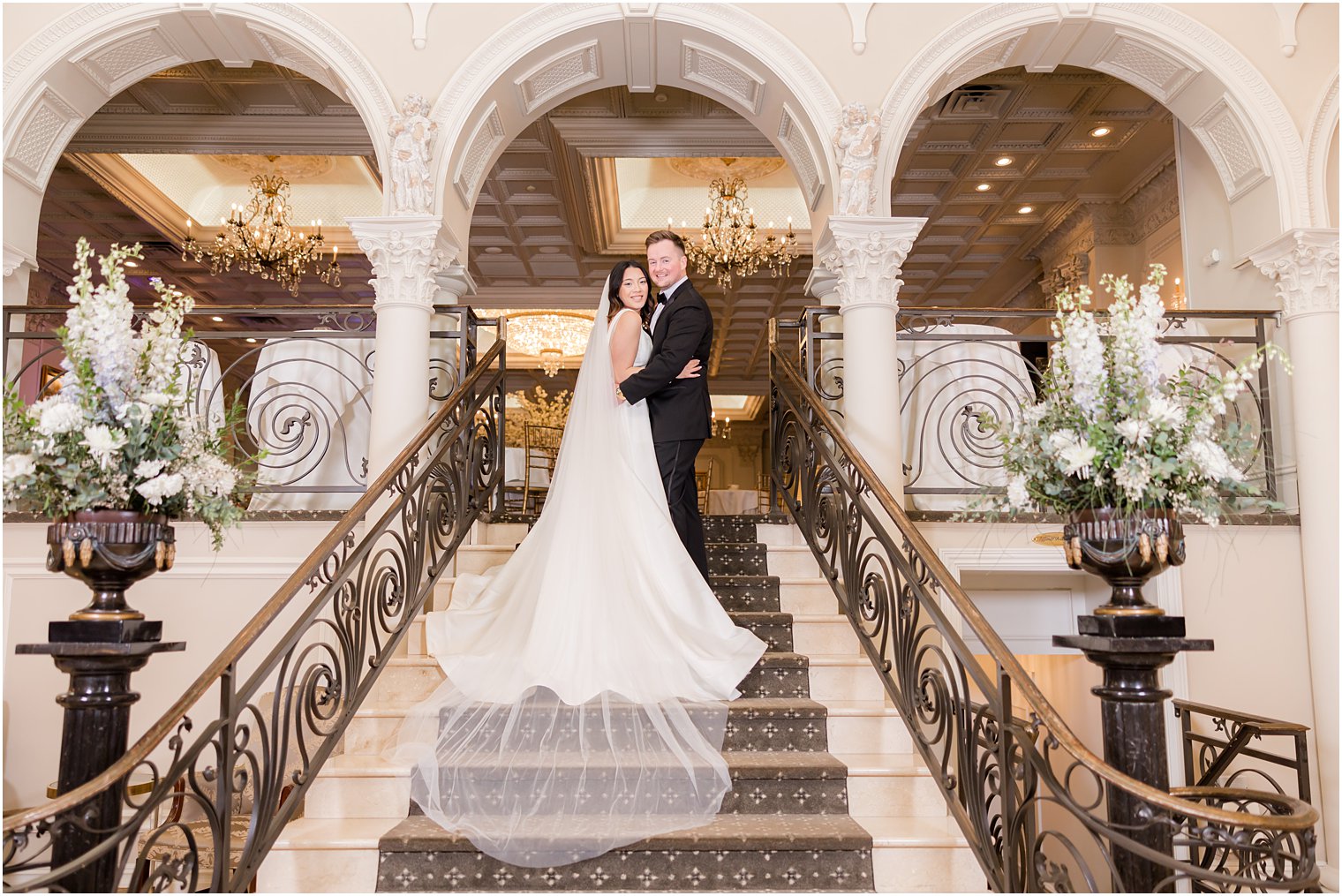 bride and groom pose on top of steps inside Nanina's in the Park