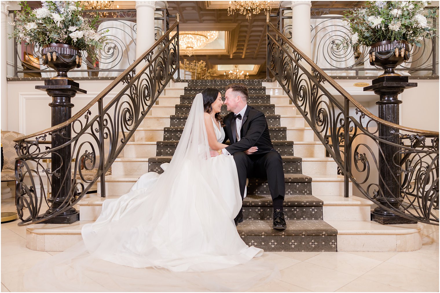 newlyweds kiss on steps inside Nanina's in the Park ksising 