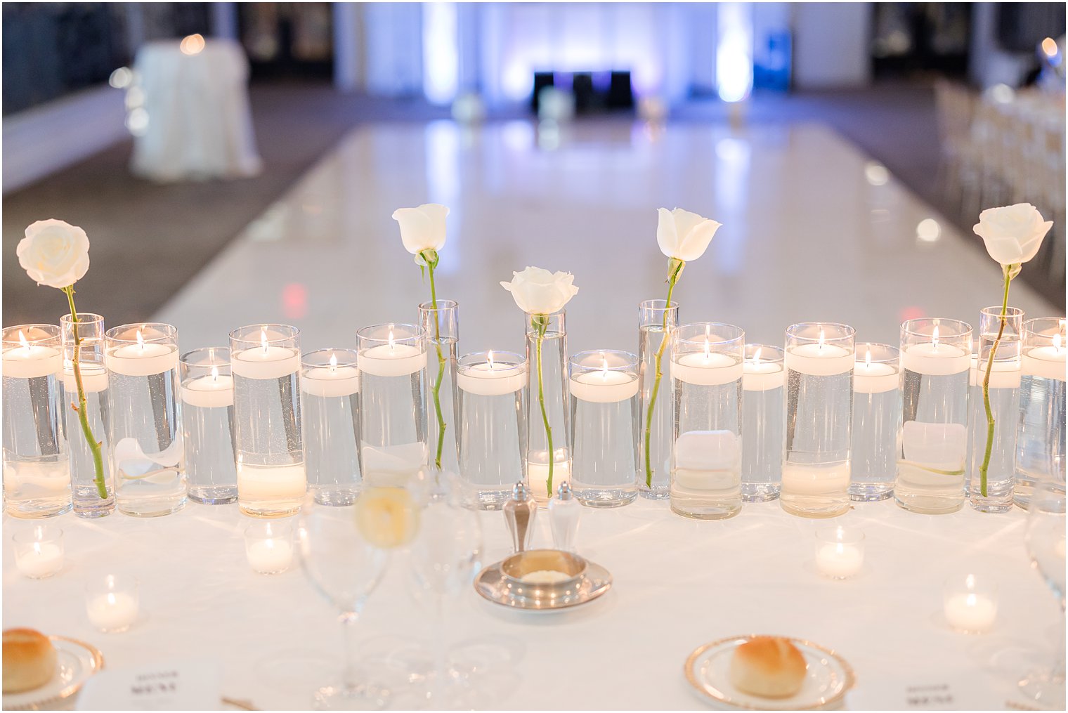 sweetheart table with white orchids and floating candles 