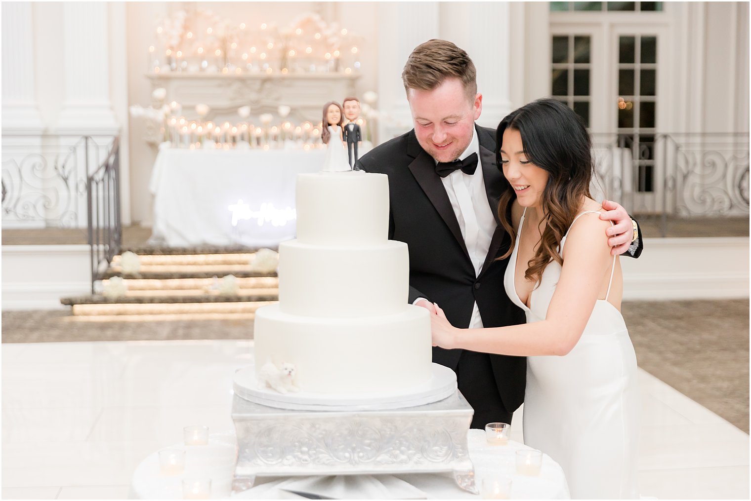 bride and groom cut wedding cake during NJ wedding reception 