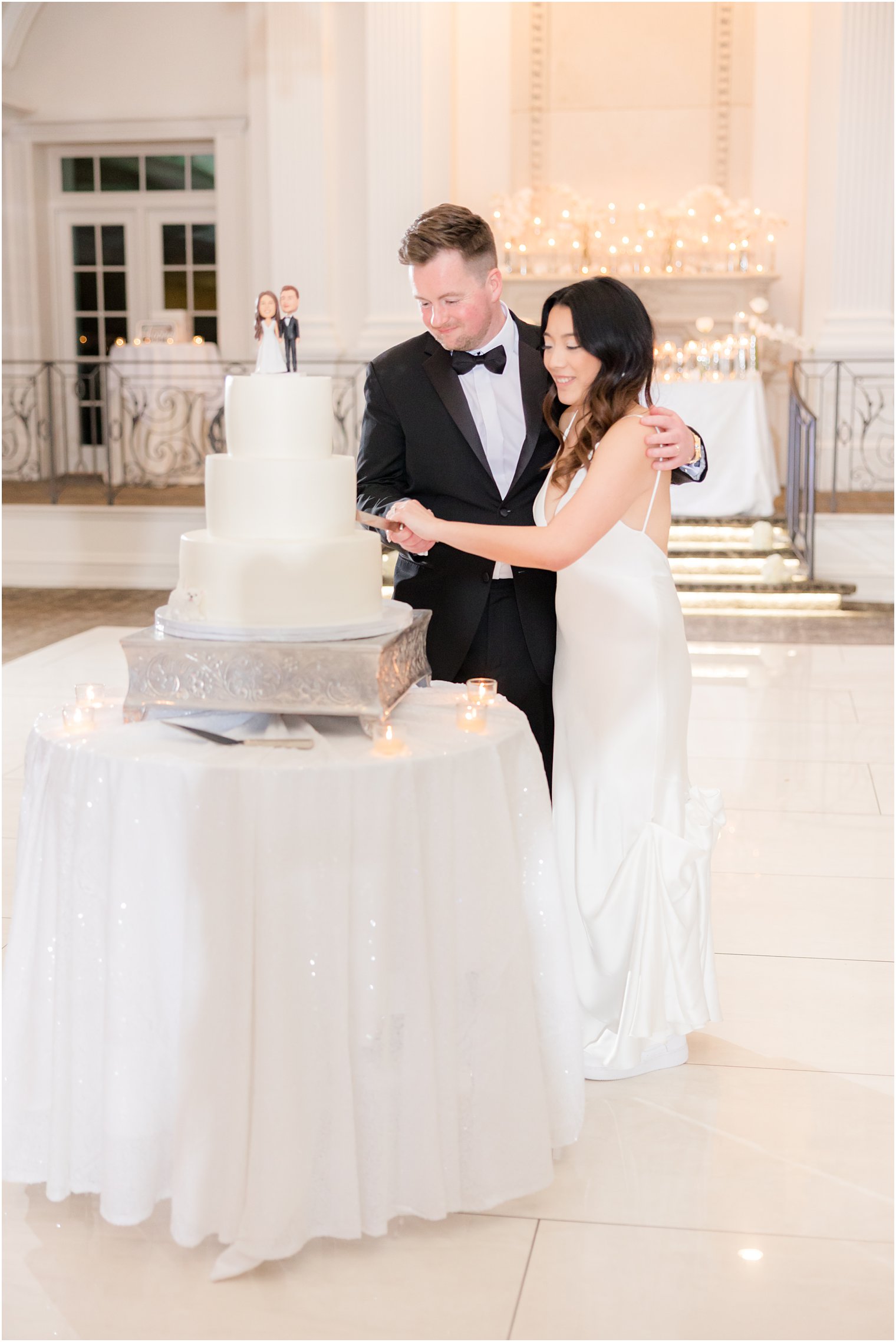 newlyweds cut wedding cake at Nanina's in the Park