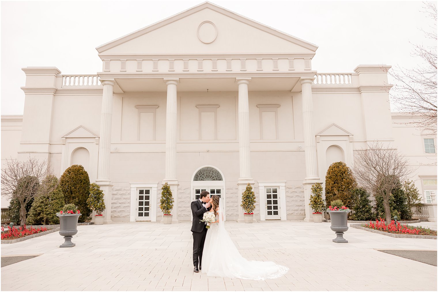 bride and groom hug in front of the Palace at Somerset Park