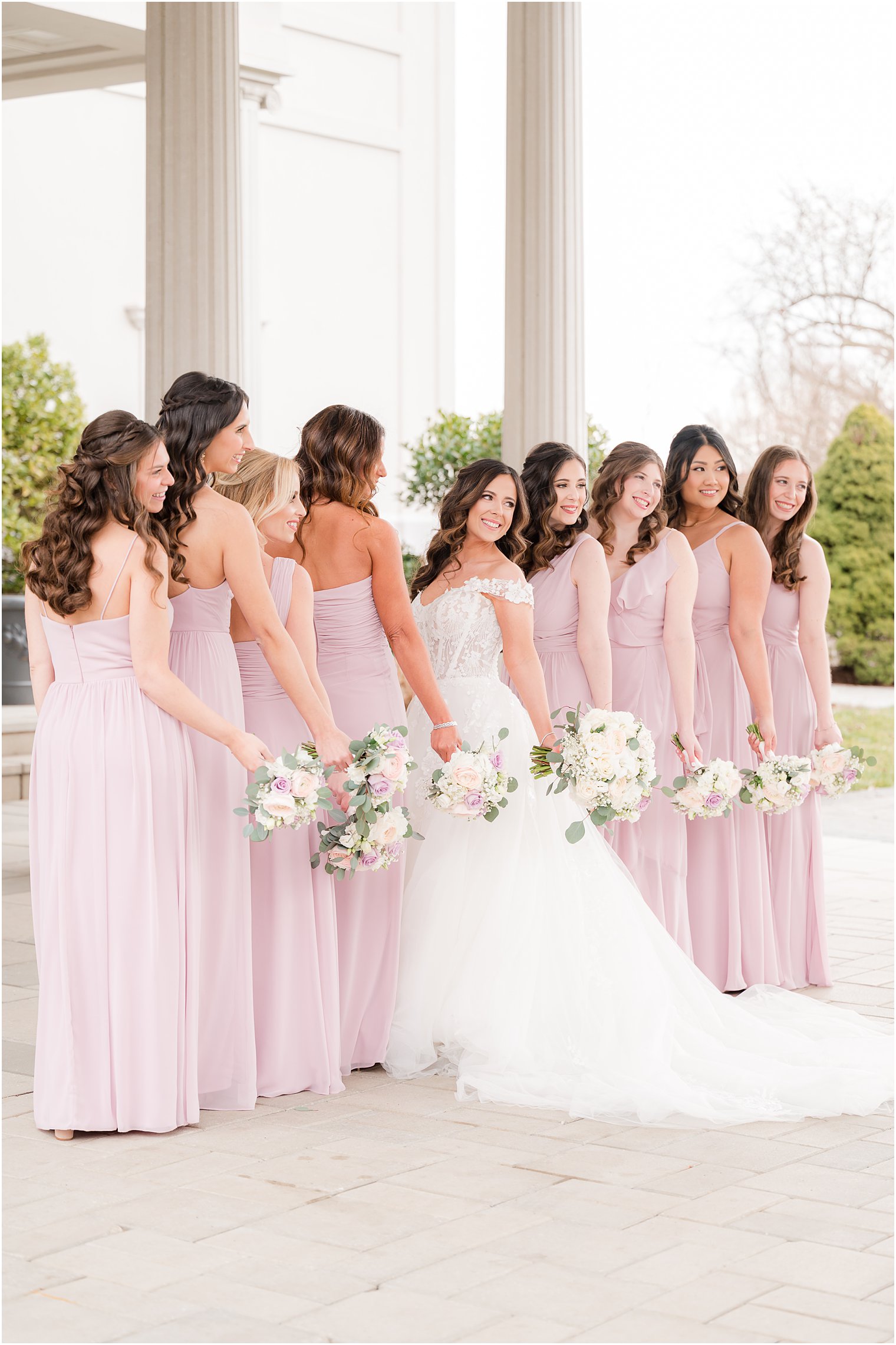 bride and bridesmaids hold bouquets of pastel roses at the Palace at Somerset Park