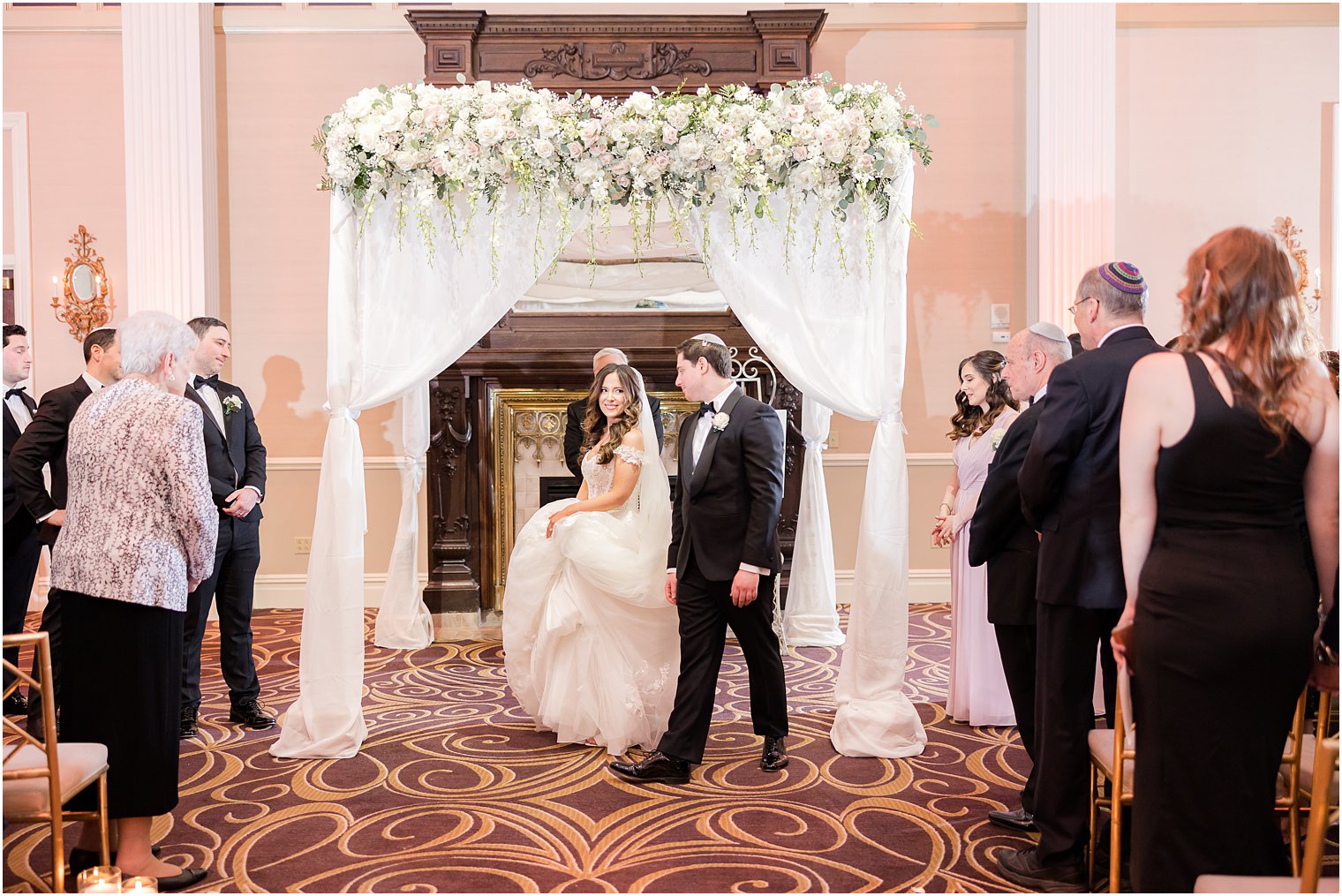 bride walks around groom under canopy for traditional Jewish wedding at the Palace at Somerset Park