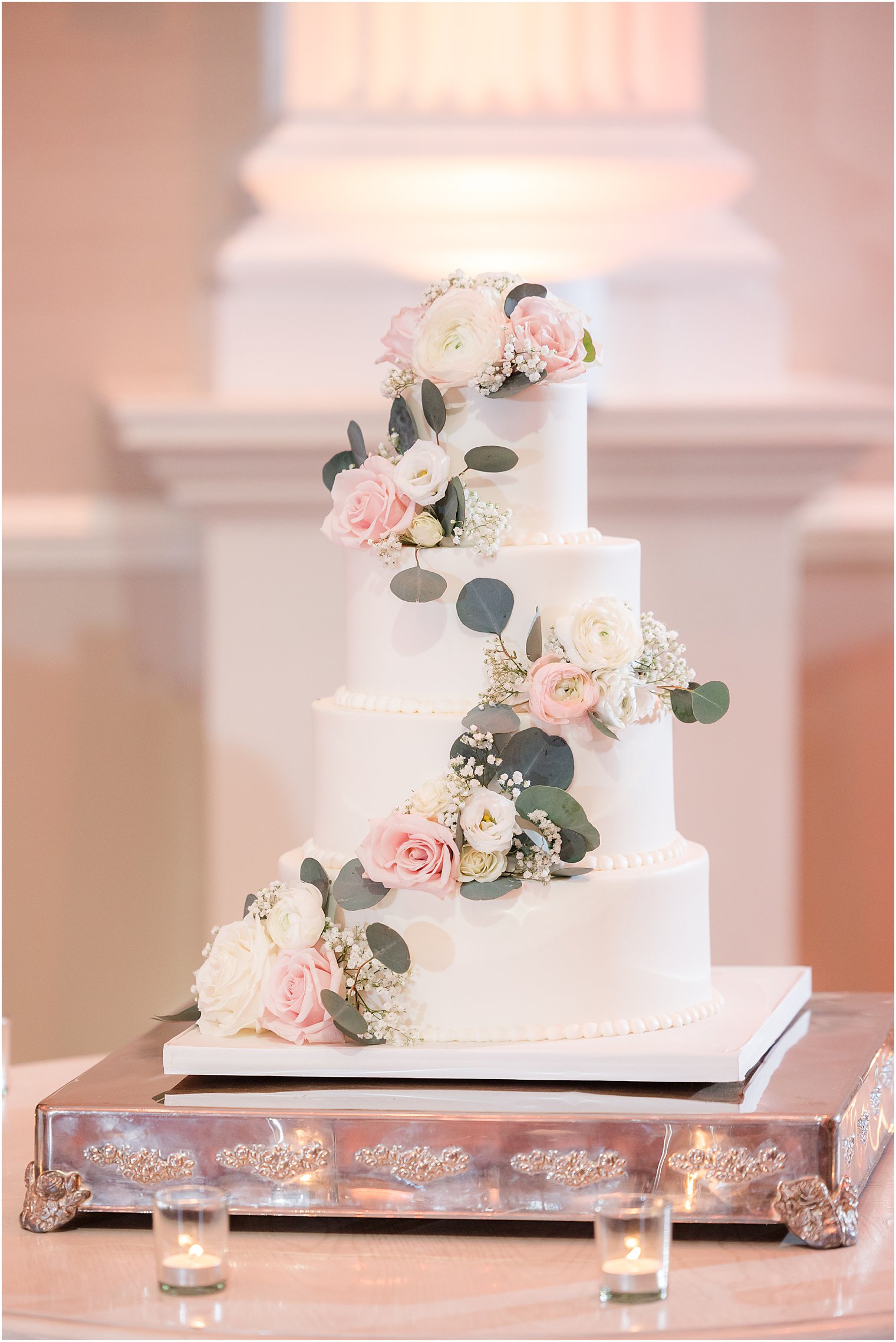tiered wedding cake with pink and white flowers 