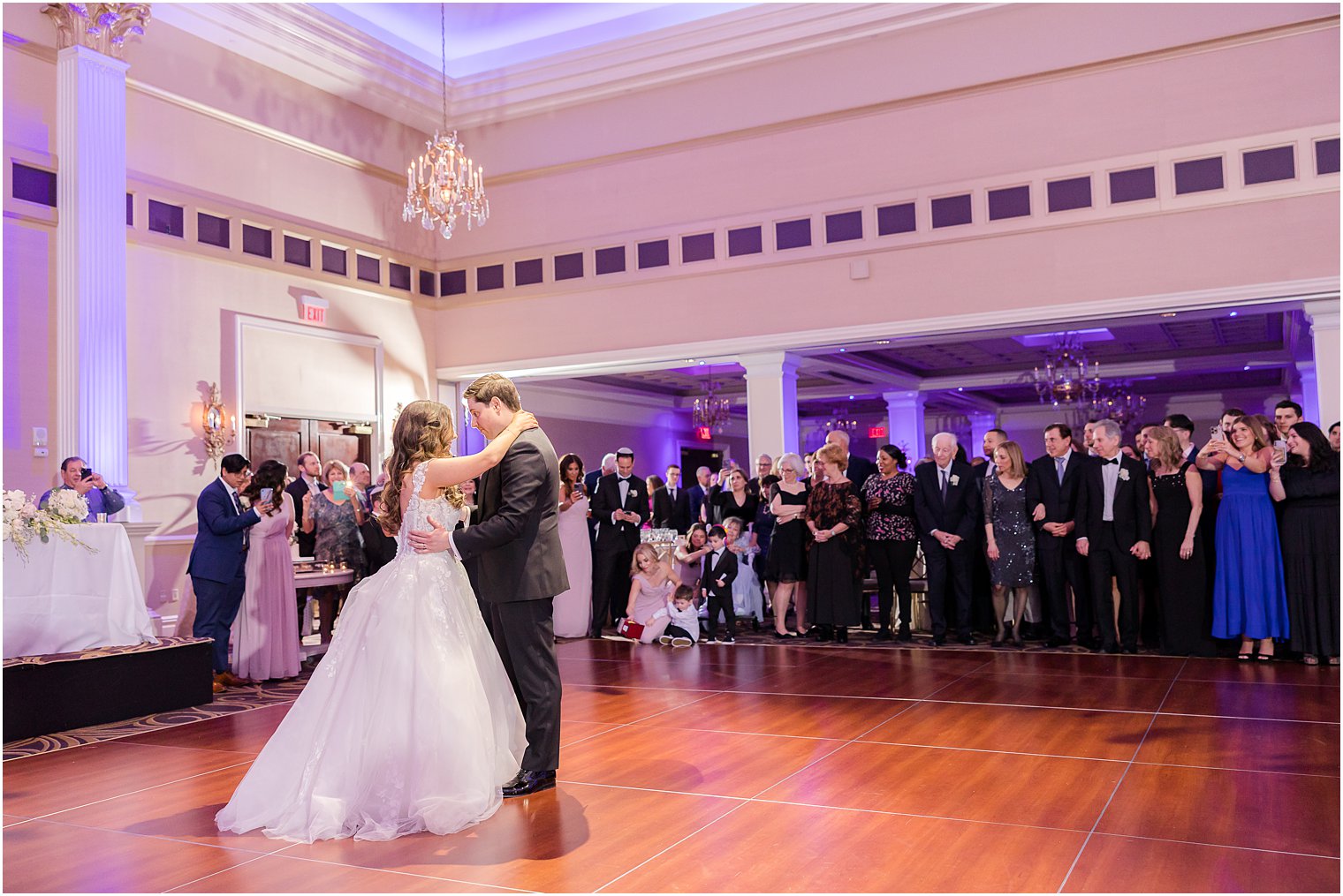 bride and groom dance in circle of guests at the Palace at Somerset Park