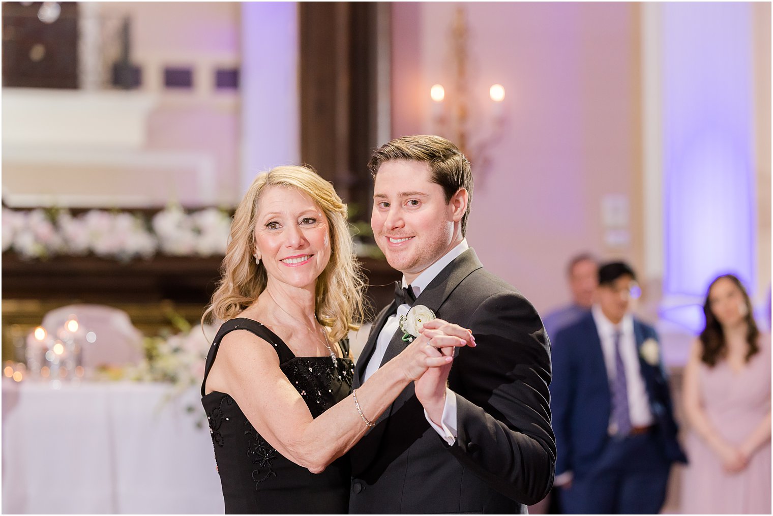 groom dances with mother during wedding reception 