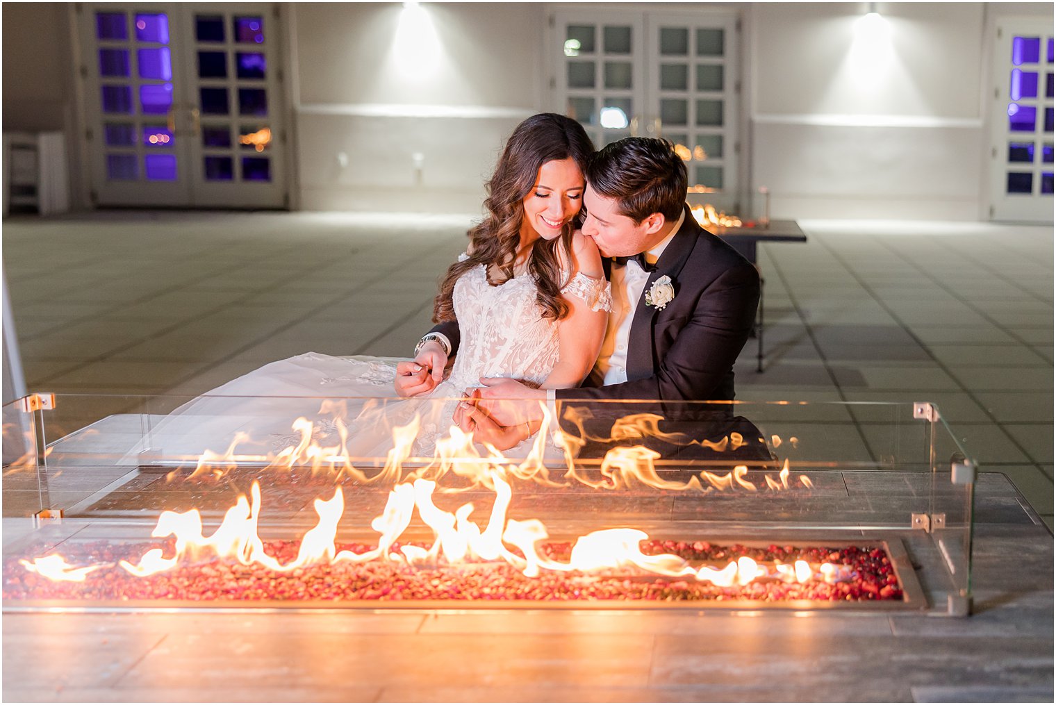 newlyweds snuggle by firepit at the Palace at Somerset Park