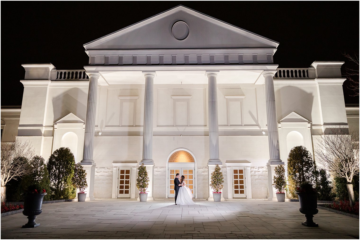 nighttime portrait of bride and groom outside the Palace at Somerset Park