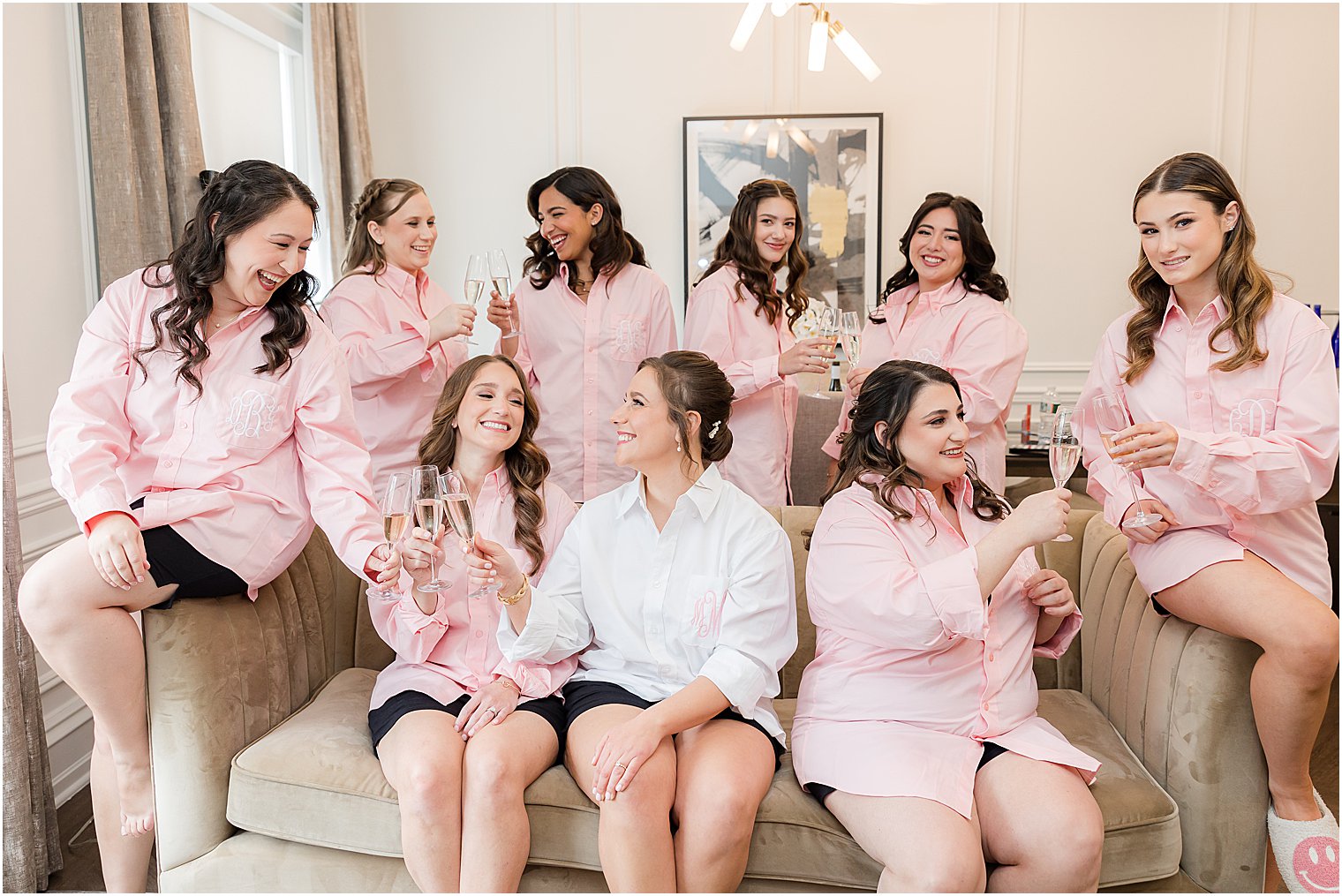 bride laughs with bridesmaids in pink pajamas 
