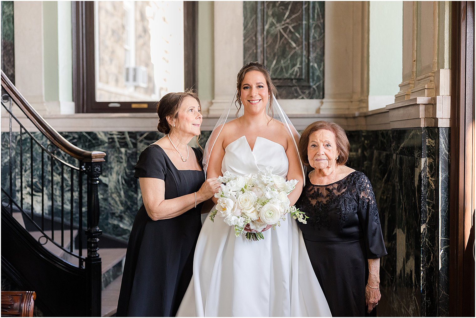 mother laughs looking at bride with grandmother at Mount Saint Mary Academy