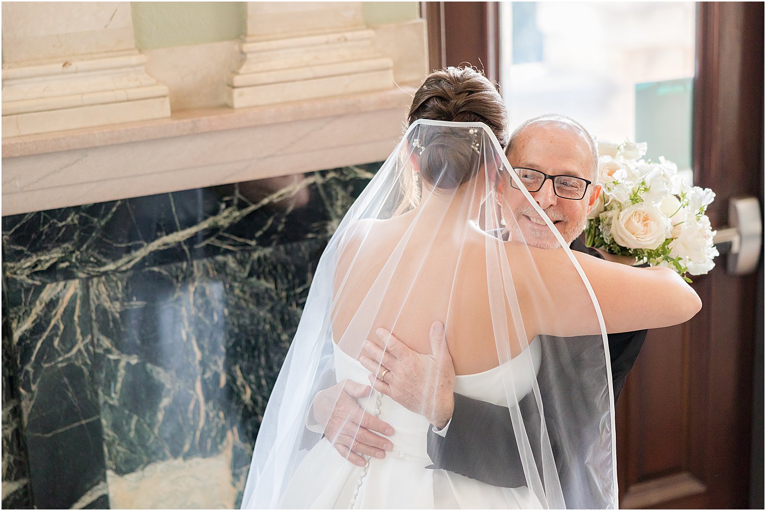 dad hugs bride during first look at Mount Saint Mary Academy