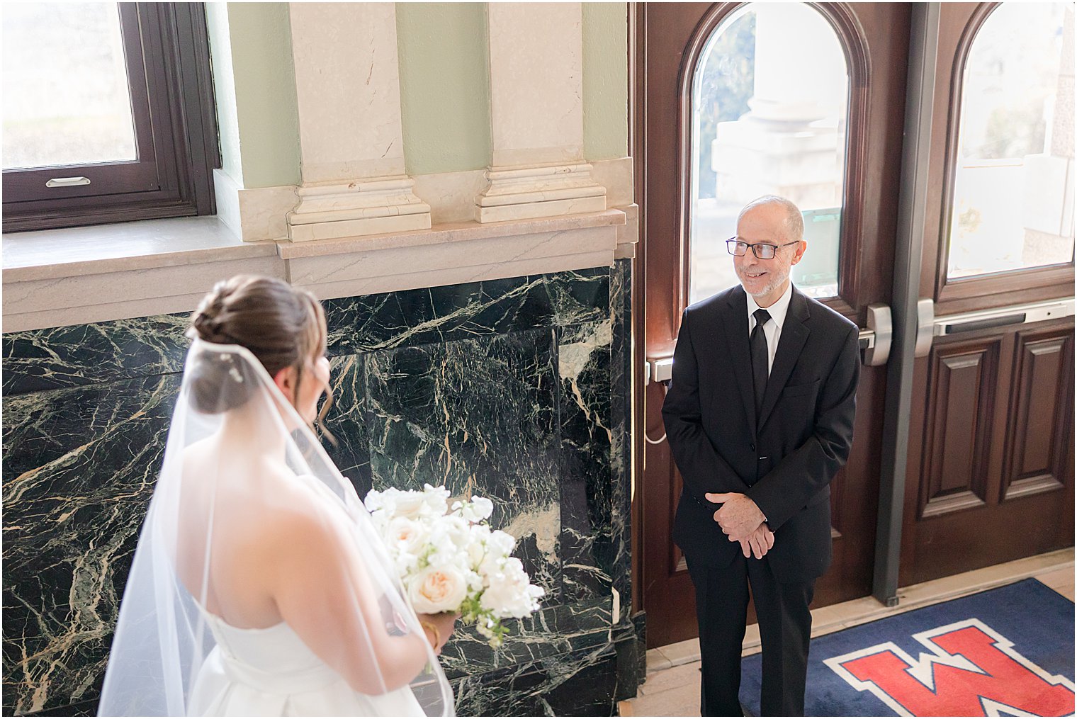 father turns to look at bride during first look at Mount Saint Mary Academy