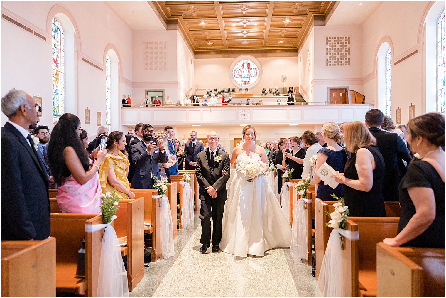 bride and father walk down aisle at the Immaculate Conception Chapel at Mount Saint Mary Academy