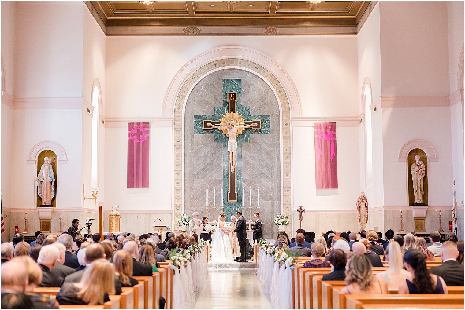 bride and groom stand at alter at the Immaculate Conception Chapel at Mount Saint Mary Academy