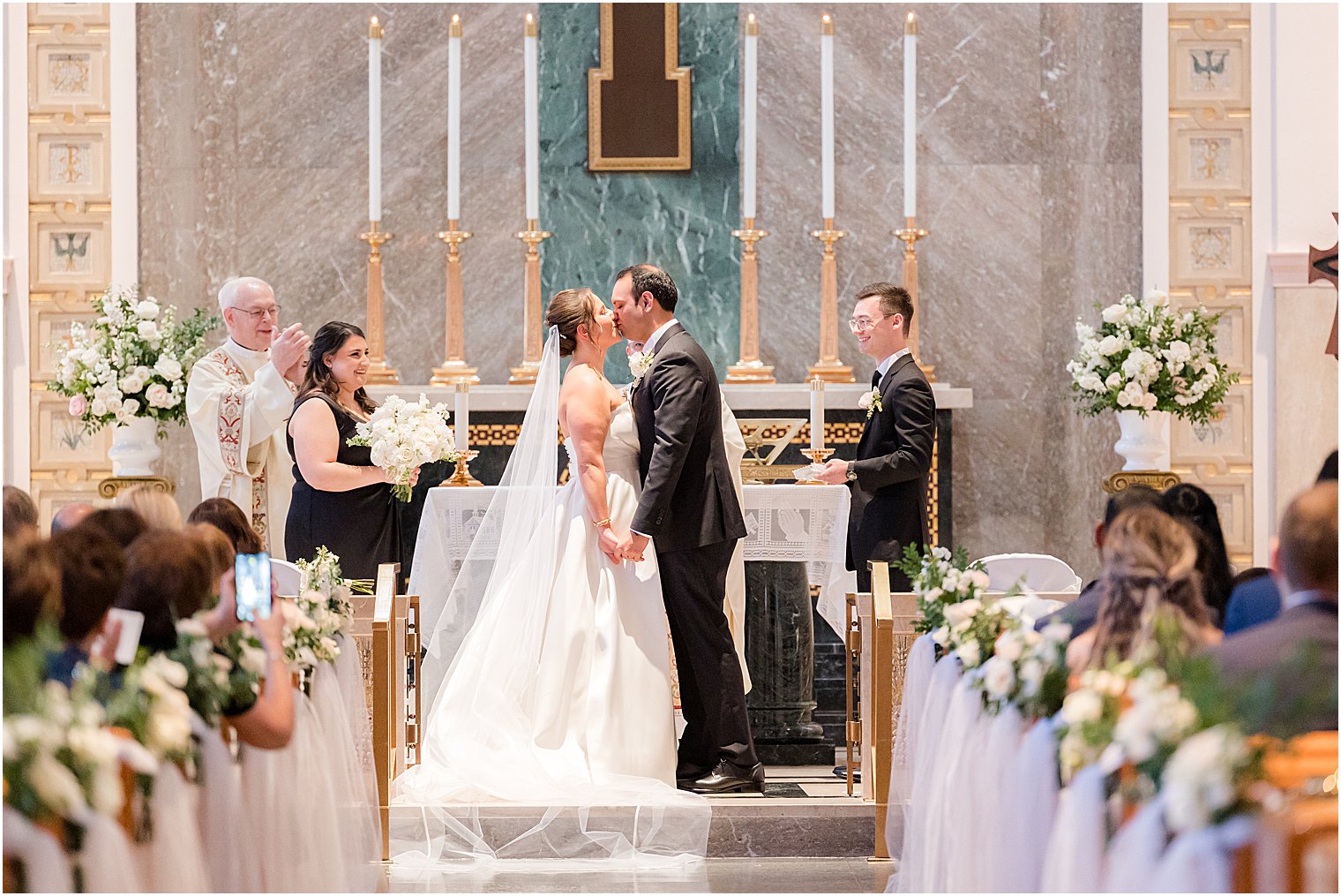 newlyweds kiss at the Immaculate Conception Chapel at Mount Saint Mary Academy