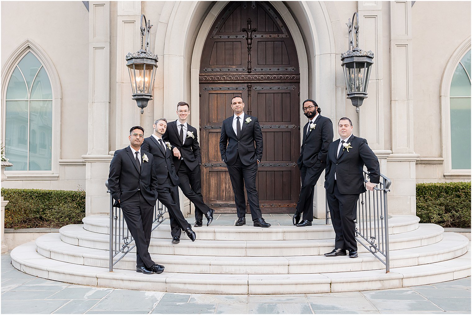 groom and groomsmen stand on steps at Park Chateau Estate chapel