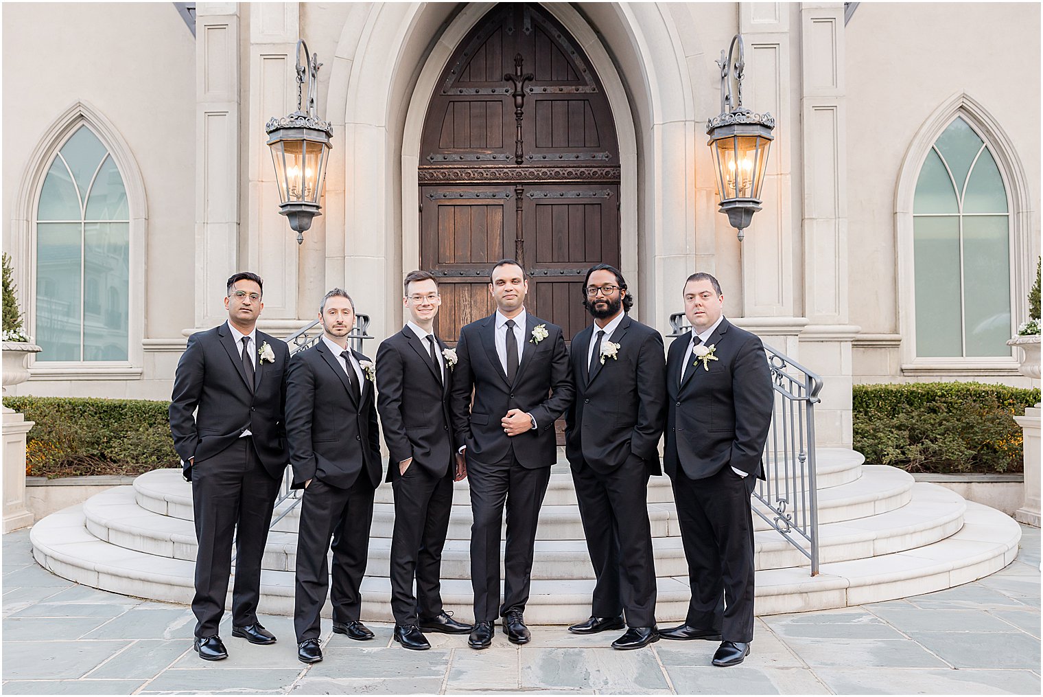 groom stands with groomsmen at Park Chateau Estate
