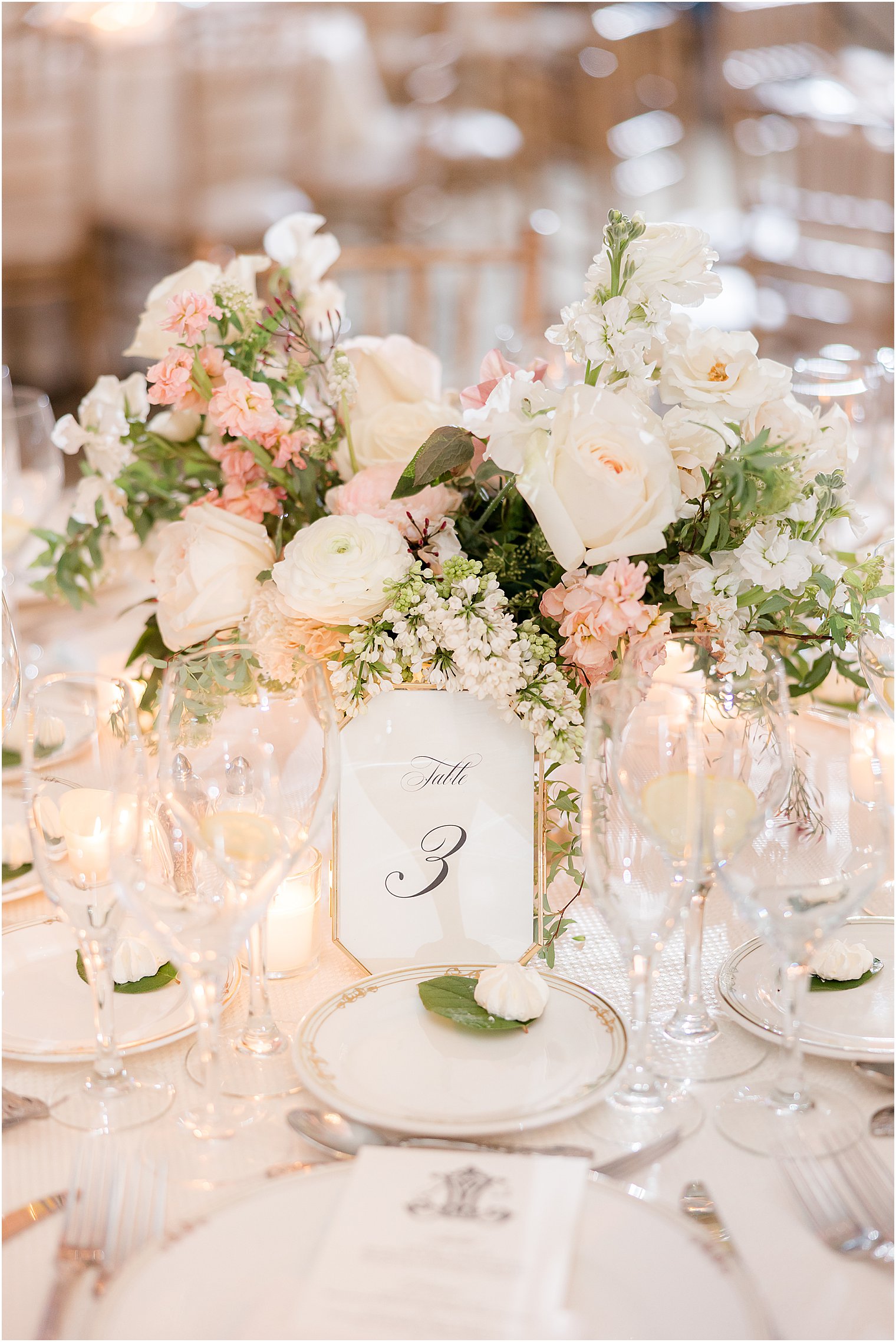 centerpiece for classic spring wedding reception at Park Chateau Estate with gold rimmed table number