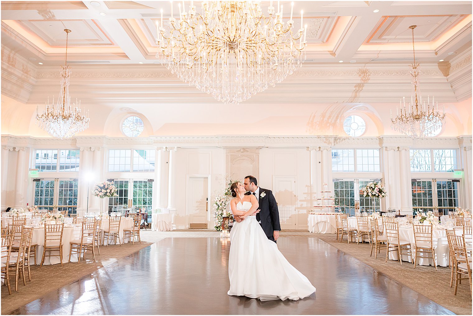 bride and groom kiss on ballroom dance floor at Park Chateau Estate