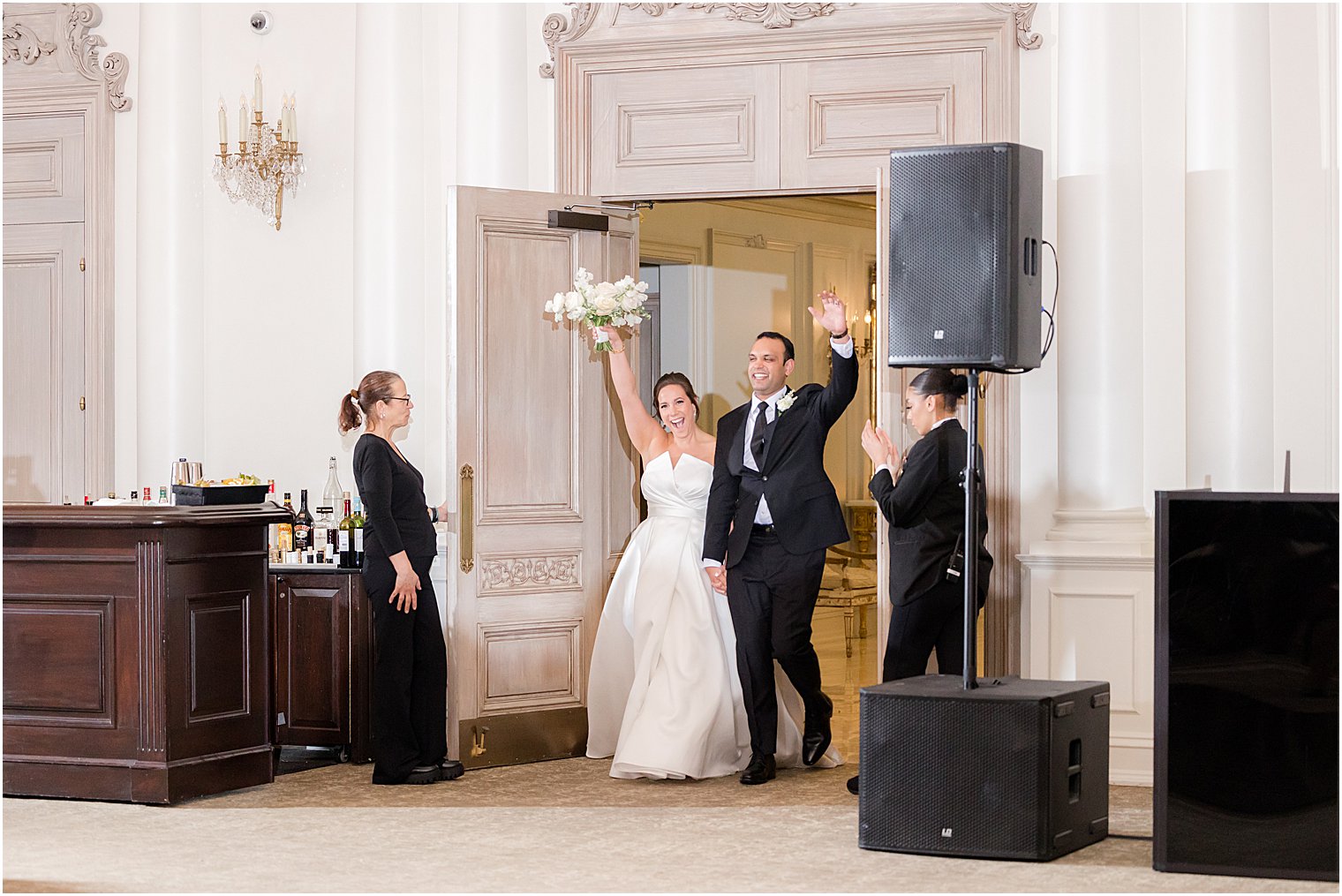 newlyweds cheer entering wedding reception at Park Chateau Estate