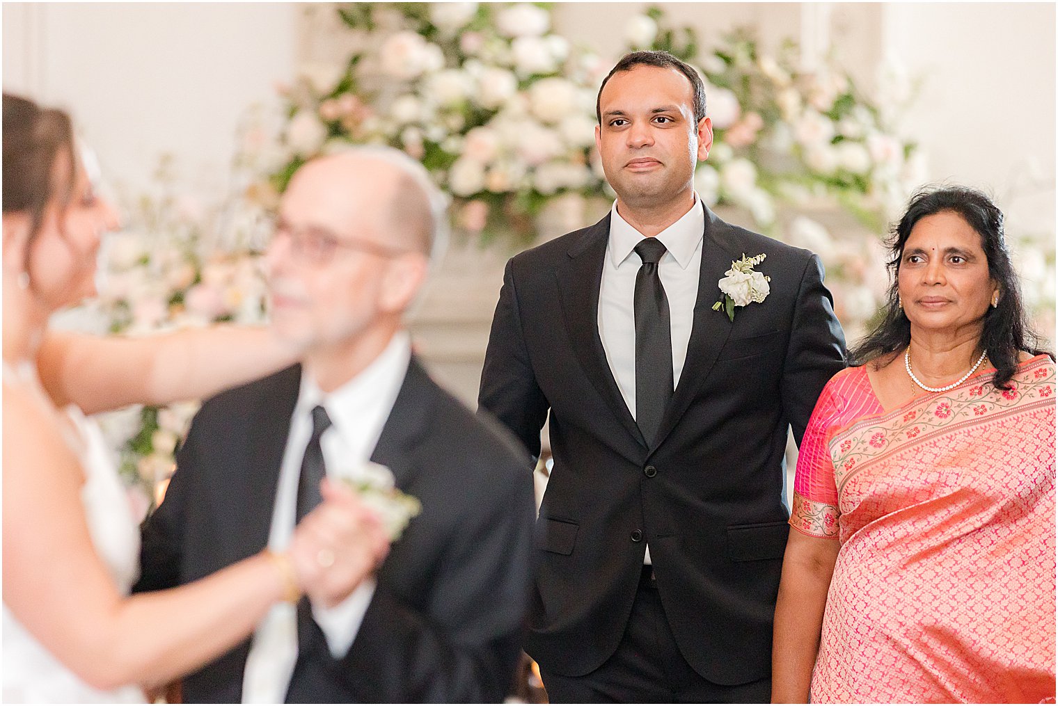 groom and mother watch bride dancing with dad 