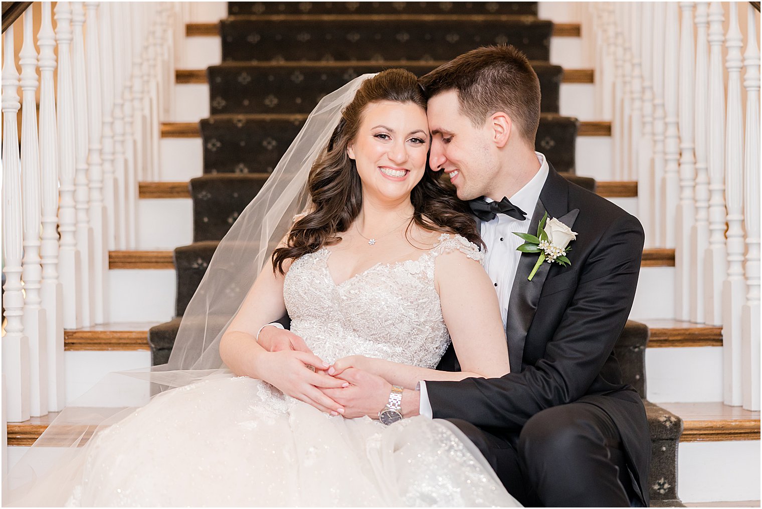 groom nuzzles bride's cheek sitting on steps at Park Savoy Estate