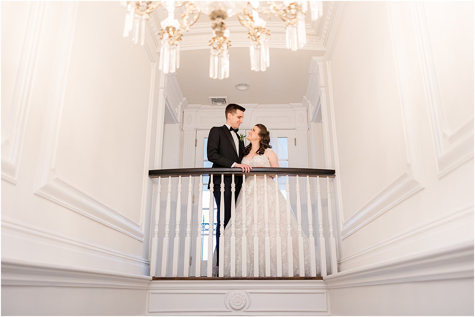 bride and groom smile at each other on balcony inside Park Savoy Estate